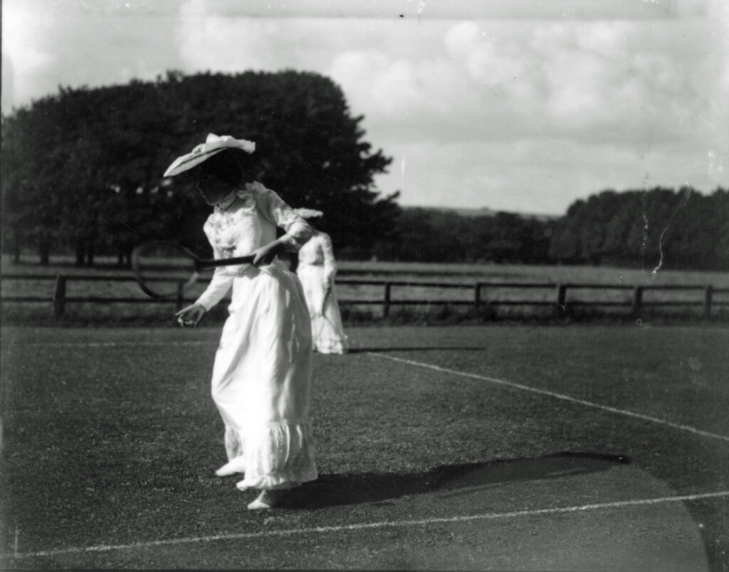 Lady tennis player with hat and long skirt